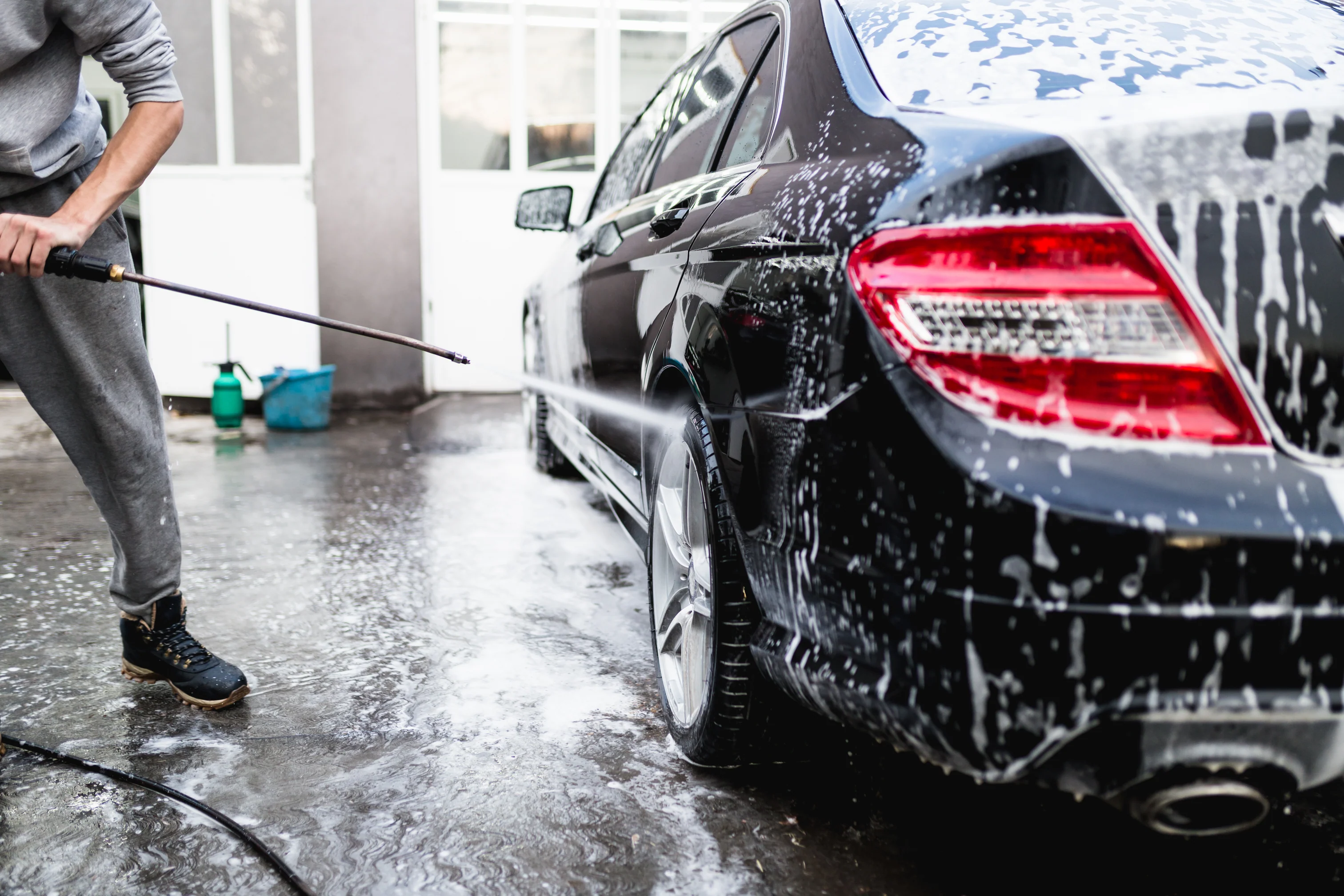 Car undergoing an exterior wash to remove road grime and surface dirt